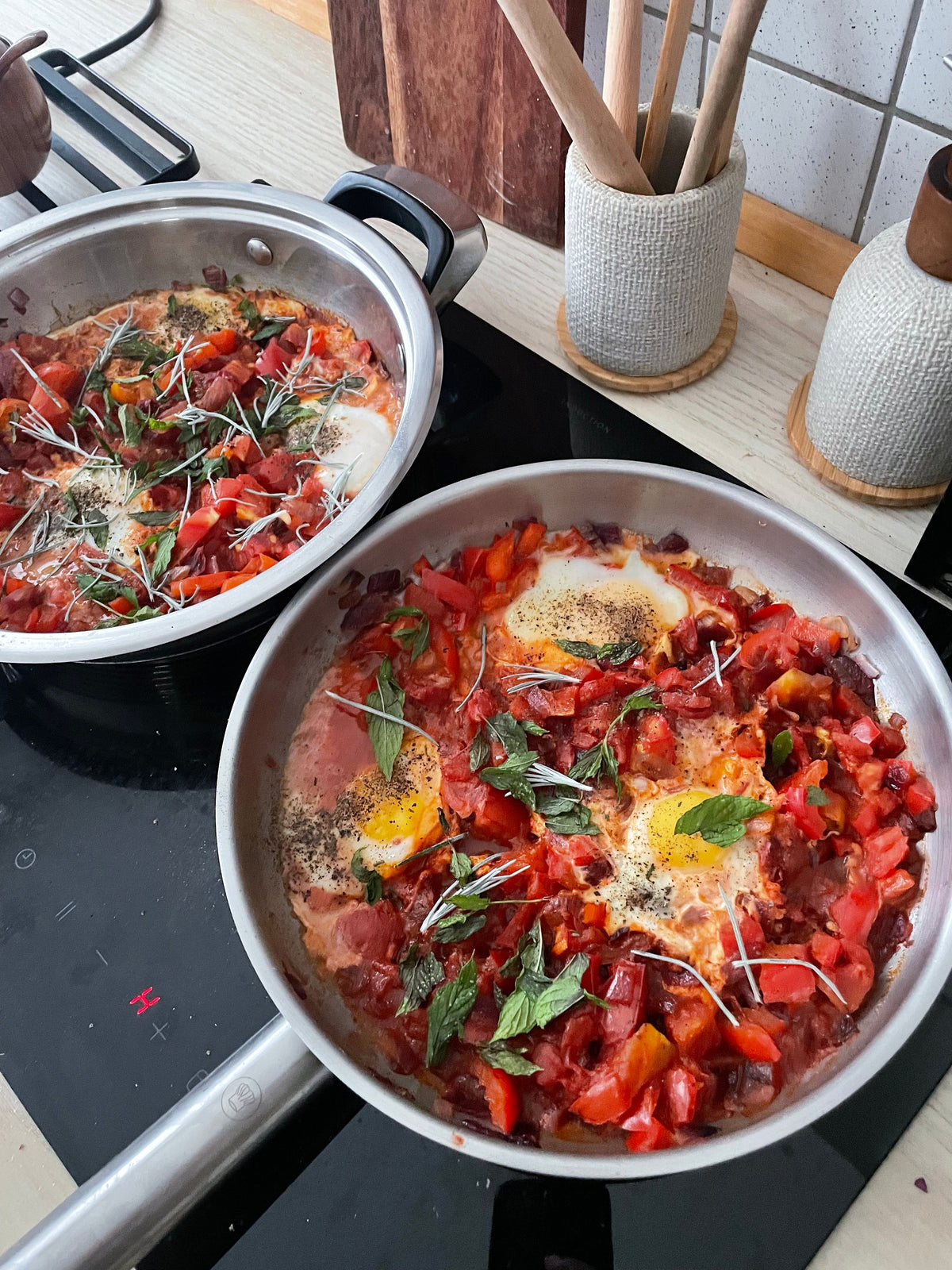 Shakshuka i stålpander på komfuret